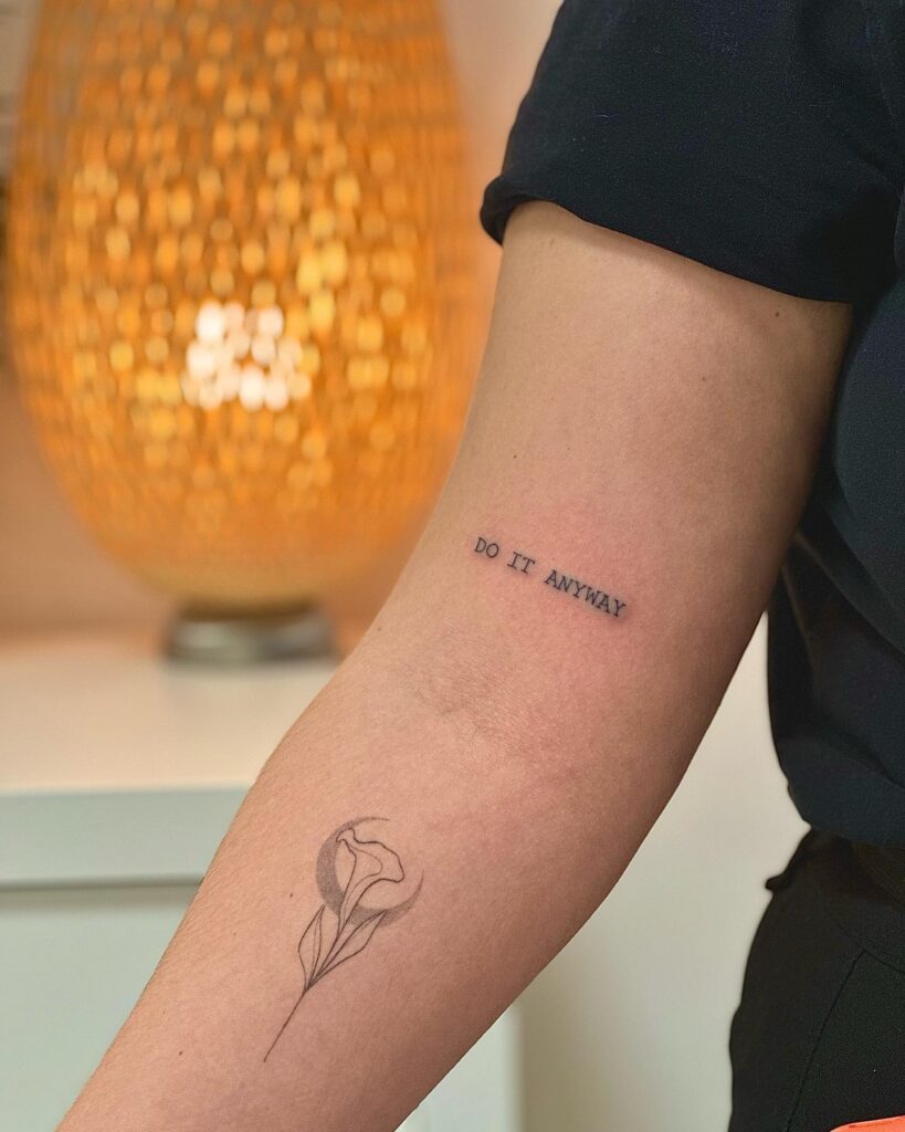 'Do It Anyway' Text Lettering Tattoo on the Above the Elbow: Bold Resilience