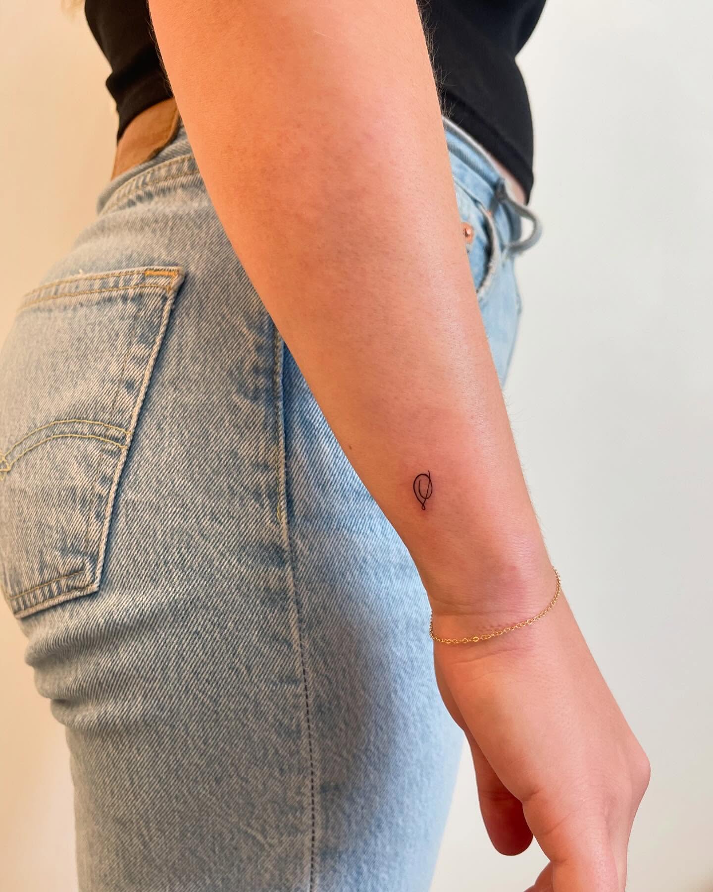 Fine Line Symbol Resembling A Stylized "s" Wrist Tattoo For Female