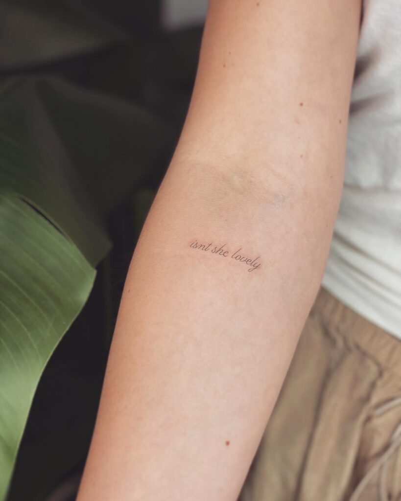 'Isn't She Lonely' Fineline Text Lettering Tattoo on the Forearm: Melancholic Musings