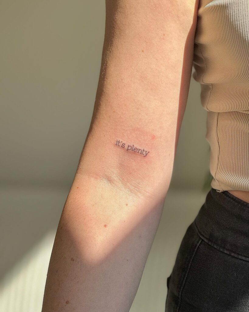 'It's Plenty' Text Tattoo on the Above the Elbow: Abundance Mindset