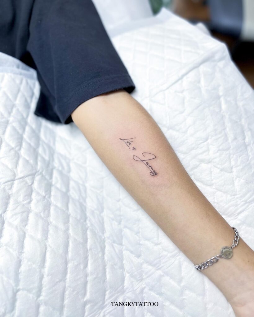 'Life is a Journey' Stylish Script Lettering Tattoo on the Forearm: Journey Affirmed