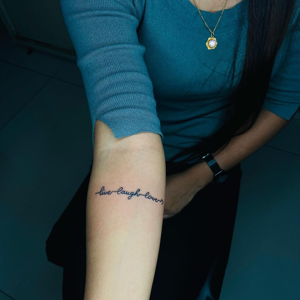 Live Laugh Love Tattoo Below the Elbow in Black Ink: Elbow Whispers