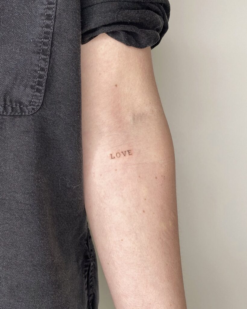 'Love' Lettering Fineline Tattoo Below the Inner Elbow: Love in Script