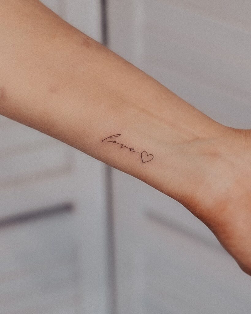 'Love' Script Lettering Tattoo on Forearm with Outline Heart: Eternal Love