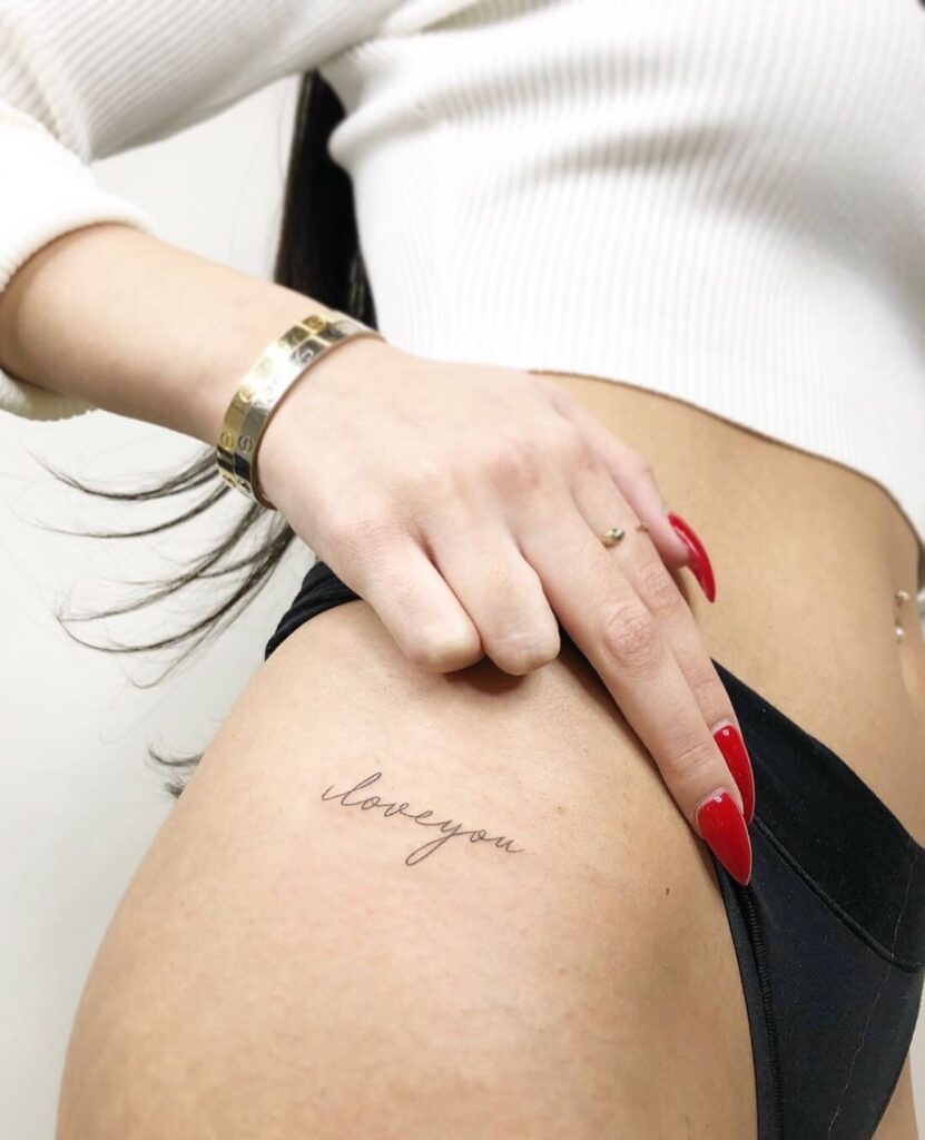 'LoveYou' Text Script Lettering Hip Tattoo, a Declaration in Stylish Cursive: Love Manifest