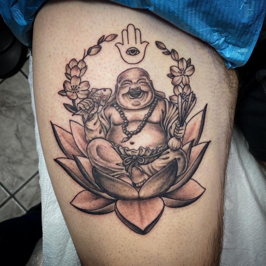 meaningful laughing buddha mens thigh tattoo spiritual reflection 