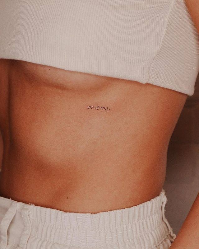 'mom' fineline rib tattoo ultra-thin lettering for a subtle tribute