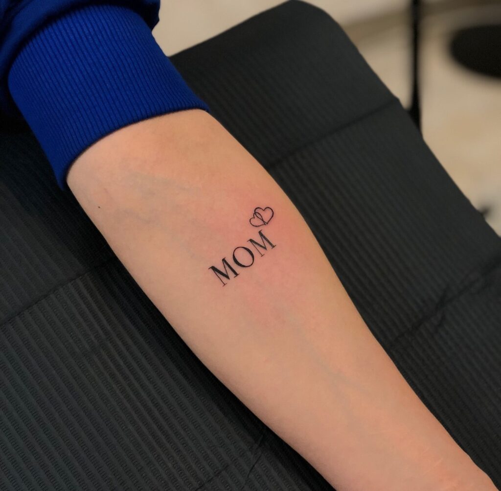 'MOM' Text Lettering Tattoo with Tender Hearts on the Forearm: Maternal Love