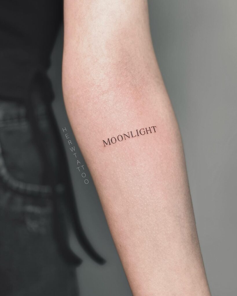 'Moonlight' Fineline Text Lettering Tattoo Casting a Spell on the Forearm: Nocturnal Whispers