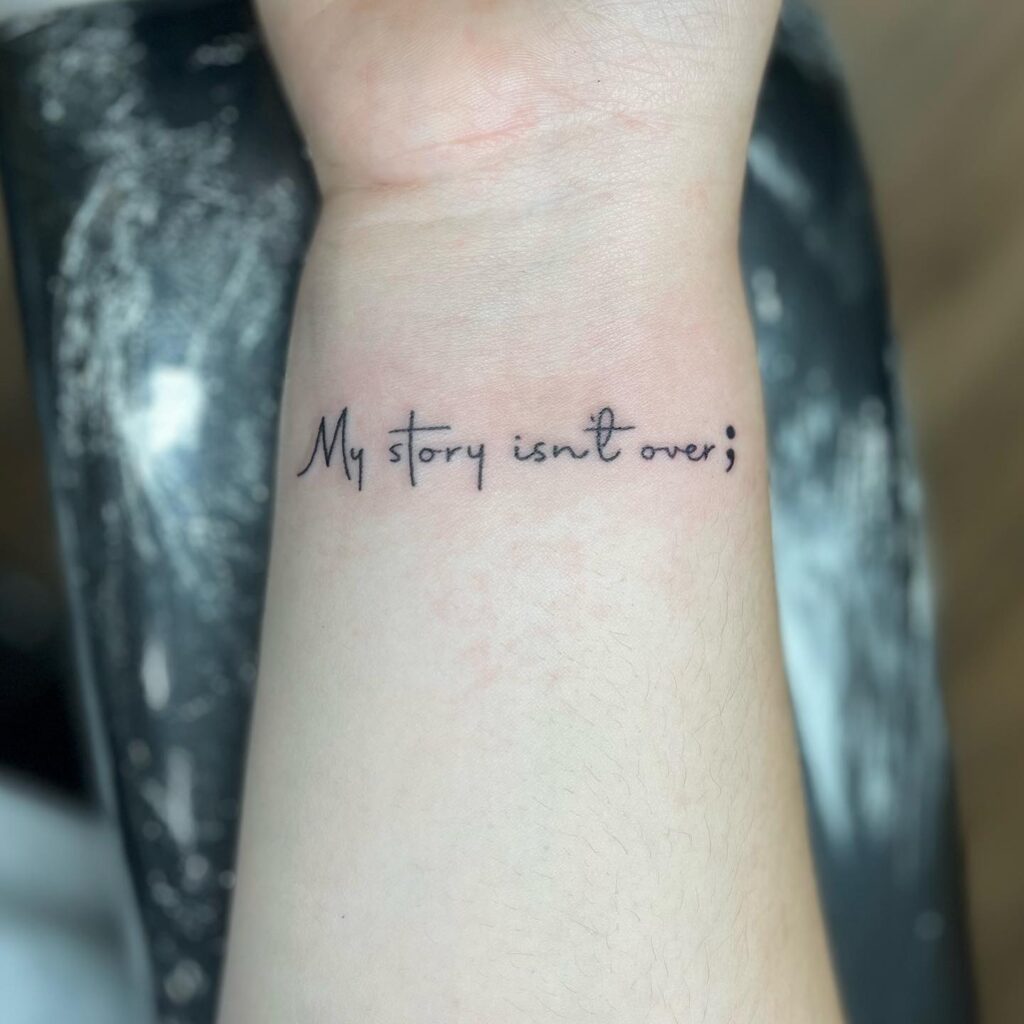 'My Story Isn't Over;' Quote Semicolon Tattoo on the Inner Wrist: Inked Resilience