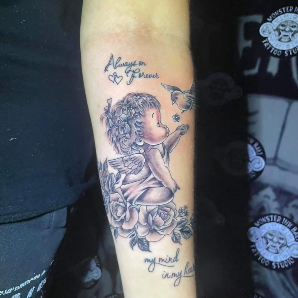 Over the Flower Baby Angel Tattoo Design
