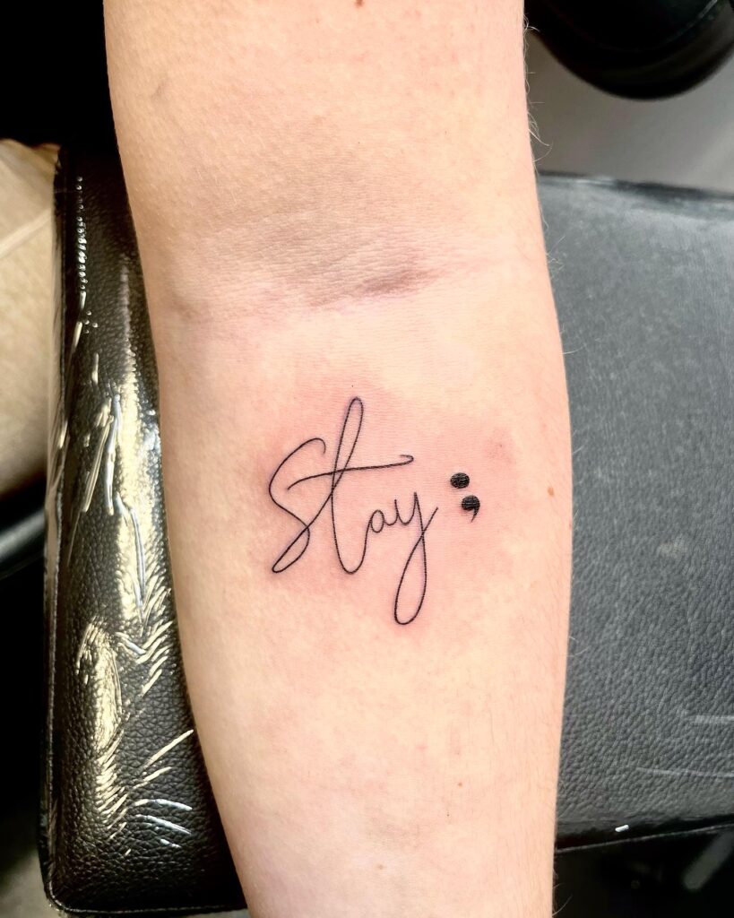 'Stay ;' Lettering Tattoo with Semicolon Below the Inner Elbow: Encouraging Reminder