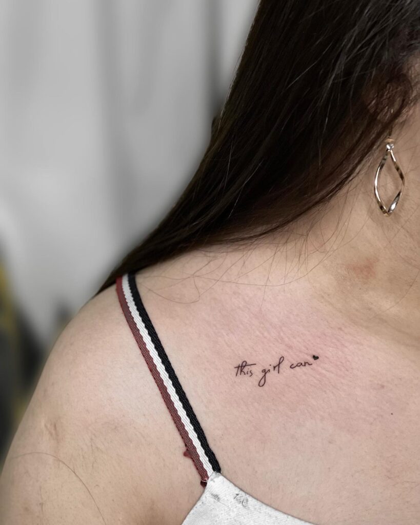 'this girl can' stylish handwriting text lettering tattoo on the collarbone, a bold affirmation girl power vibe