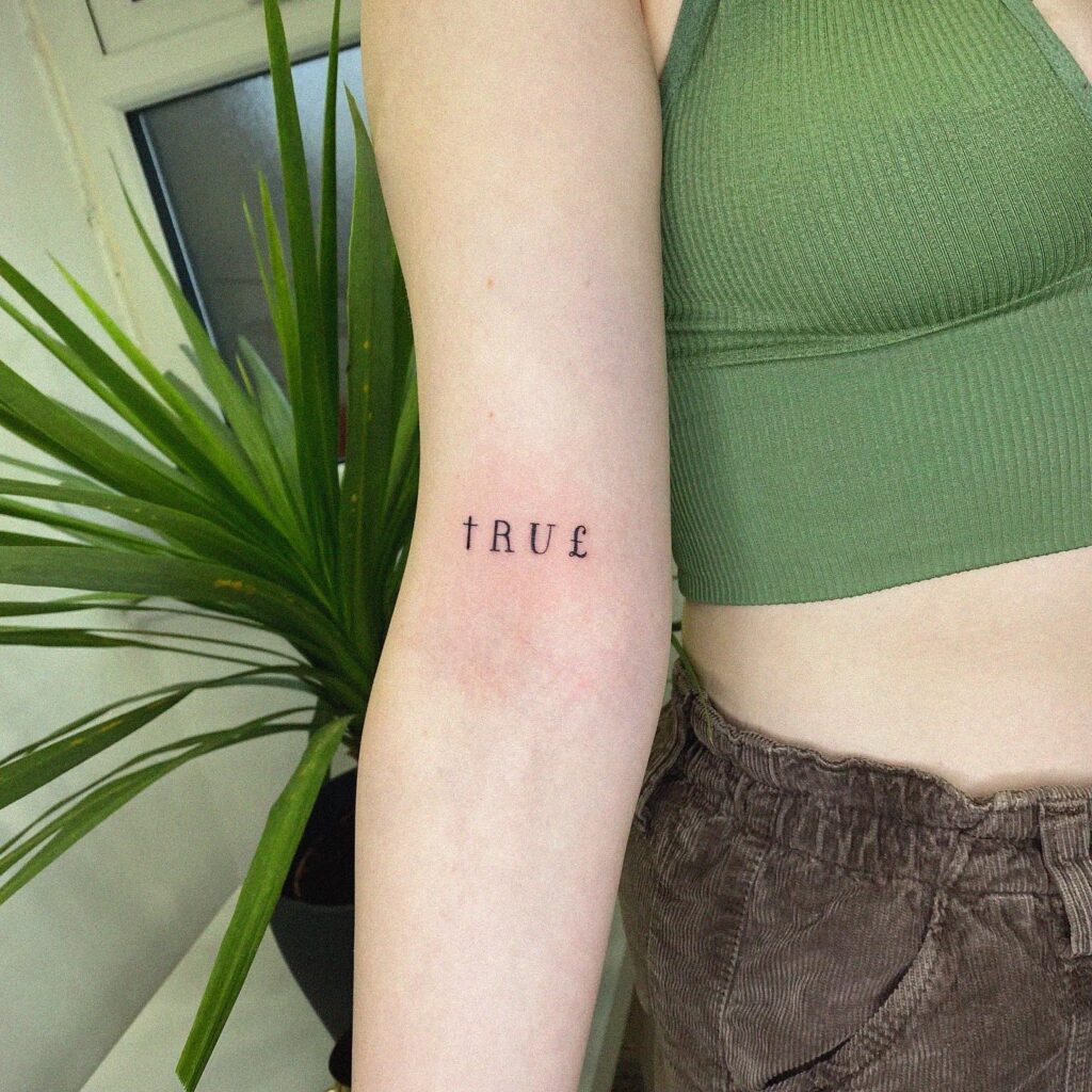 'True' Stylish Text Lettering Tattoo on the Above the Elbow: Authentic Expression