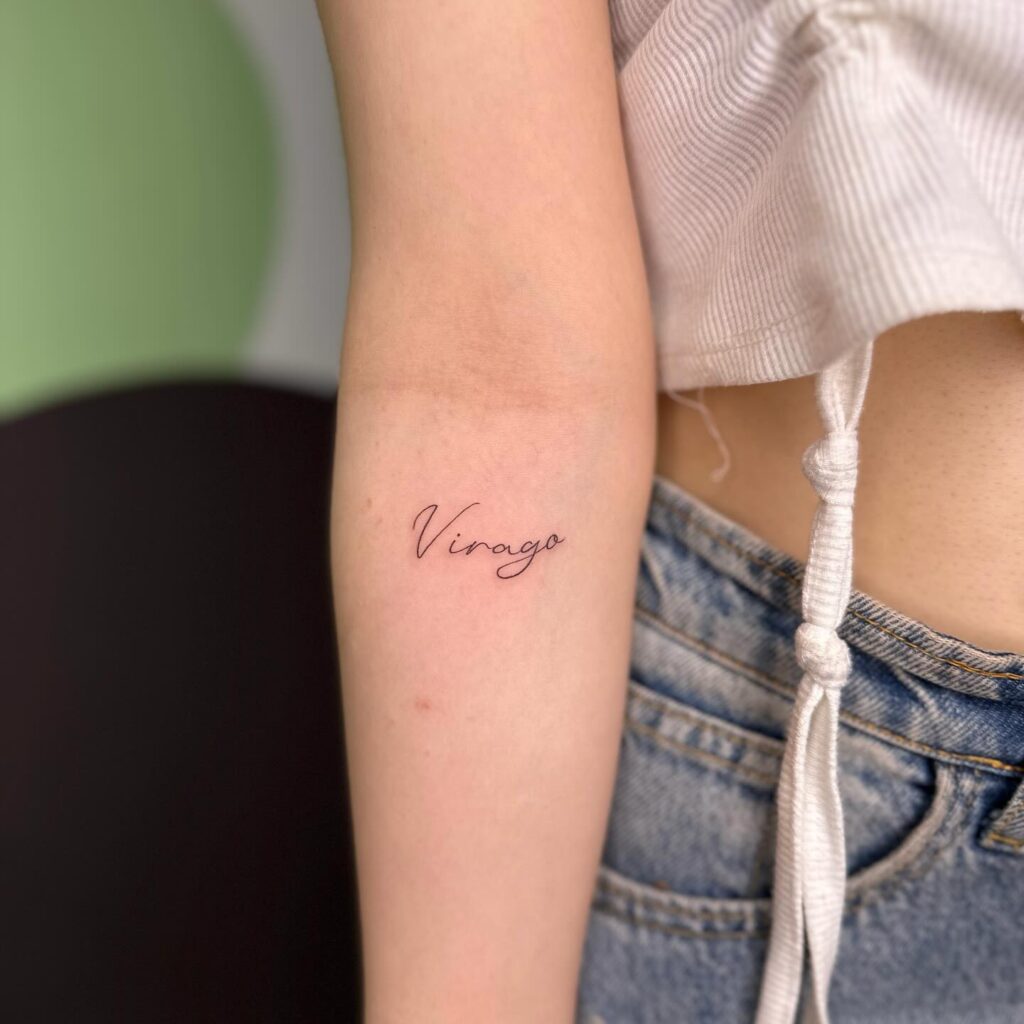 'Virago' Minimal Text Lettering Tattoo on the Forearm: Empowerment Ink