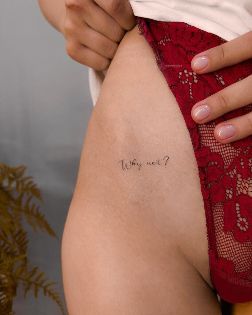 'Why Not' Fineline Text Script Lettering Tattoo on the Hip: Bold Affirmation, a Motivational Whisper
