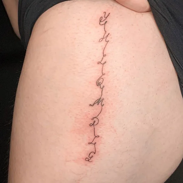 yhlqmdlg thigh tattoo
